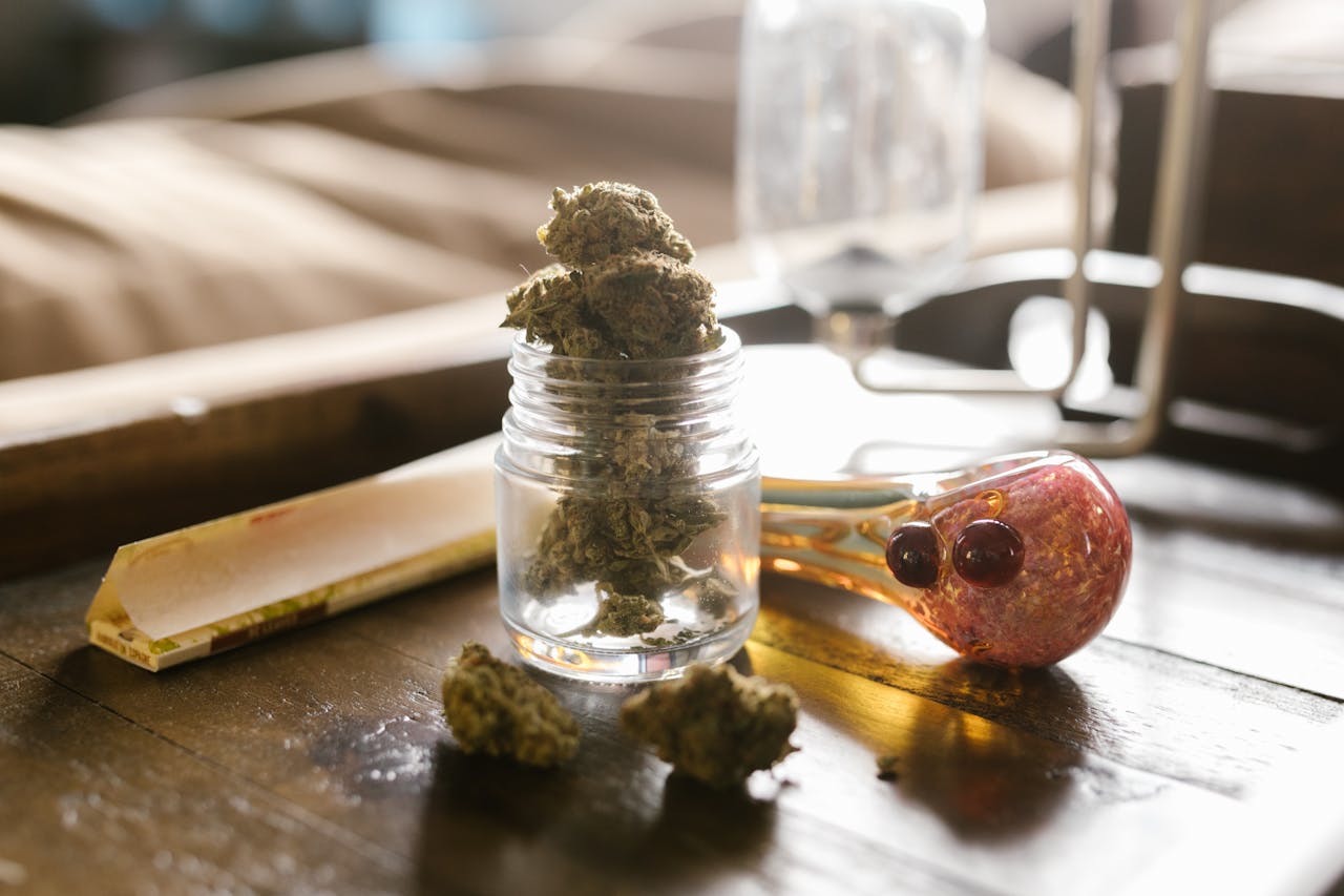 services-01 Close-up photo of cannabis buds with a glass pipe and jar, perfect for lifestyle or cannabis-related content.